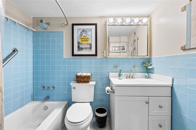 7200 Sunshine Skyway Ln S Unit 4B, Saint Petersburg, FL 33711 - full bathroom with vanity, tile walls, tub / shower combination, and wainscoting