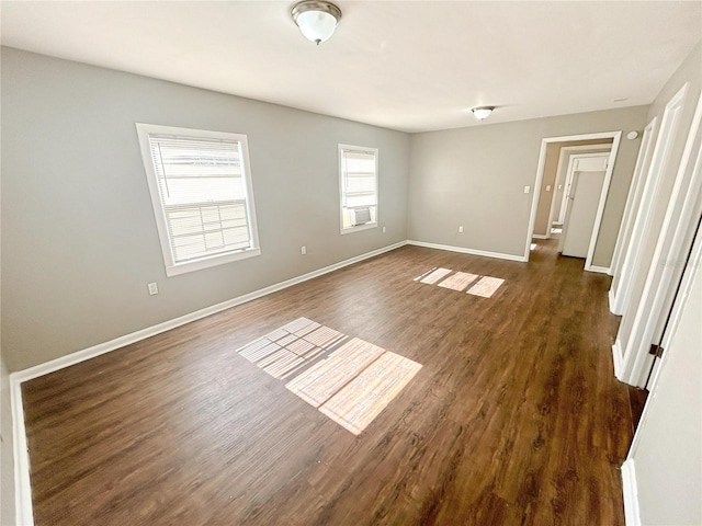 unfurnished bedroom featuring dark wood-style flooring and baseboards