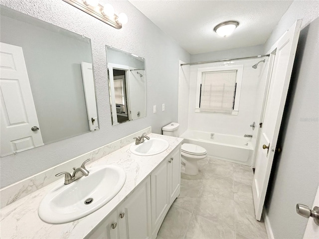 full bathroom featuring toilet, a textured ceiling,  shower combination, and a sink