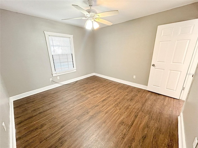 unfurnished room with baseboards, a ceiling fan, and wood finished floors