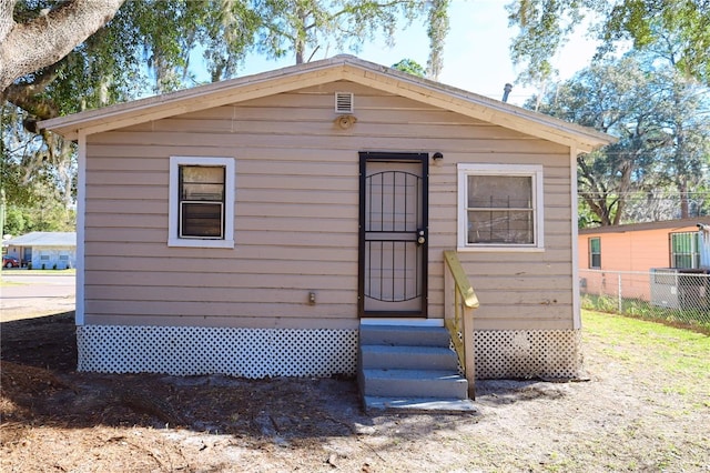 view of outbuilding with fence