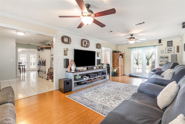 living room featuring ceiling fan, ornamental molding, french doors, and visible vents