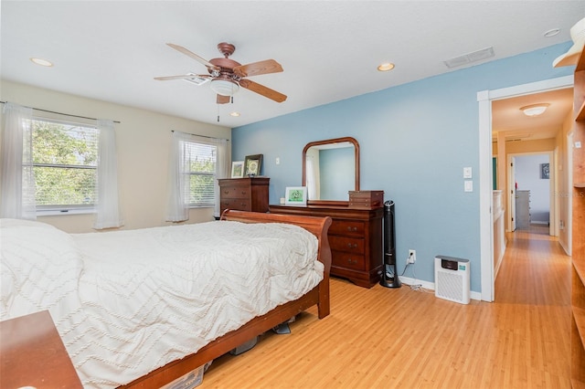 bedroom featuring light wood-style flooring, a ceiling fan, visible vents, baseboards, and recessed lighting