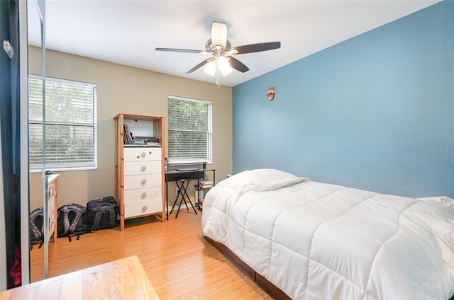 bedroom with ceiling fan and wood finished floors