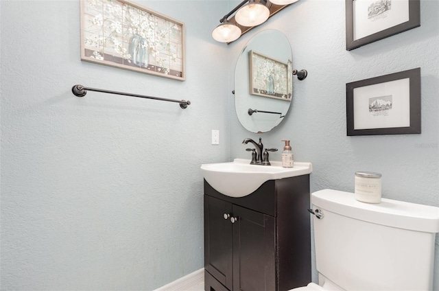 half bath with vanity and toilet