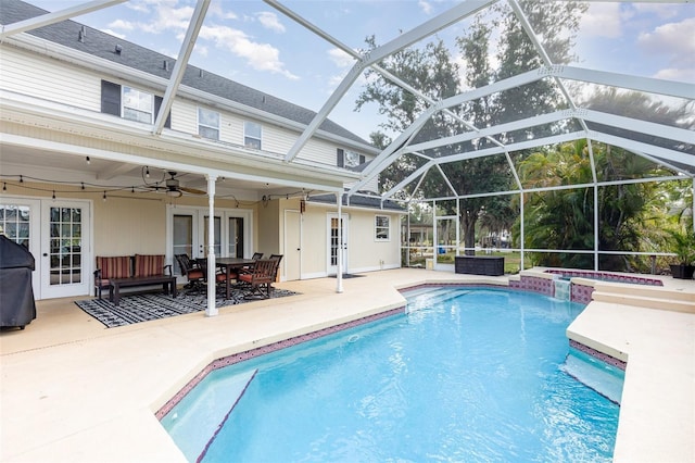 view of pool with a pool with connected hot tub, french doors, a patio, ceiling fan, and grilling area