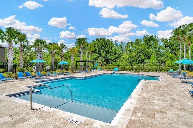 pool featuring a patio and fence