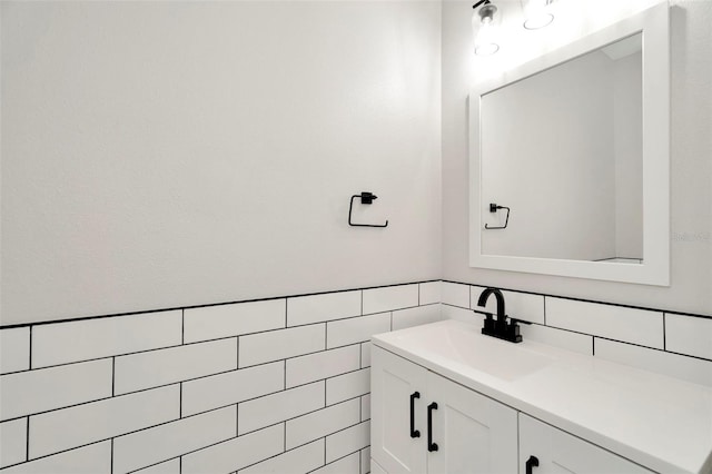 bathroom featuring tile walls, tasteful backsplash, and vanity