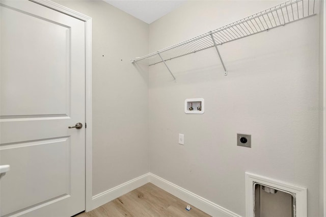 laundry room with laundry area, electric dryer hookup, baseboards, hookup for a washing machine, and light wood-style floors