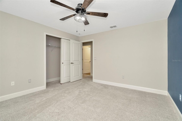 unfurnished bedroom featuring baseboards, light carpet, a closet, and visible vents
