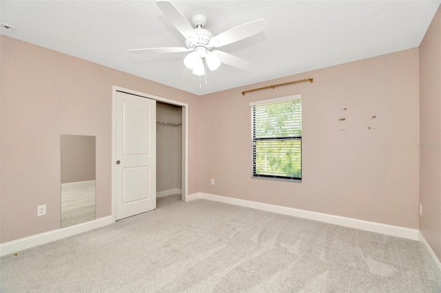 unfurnished bedroom with baseboards, light carpet, ceiling fan, and a closet