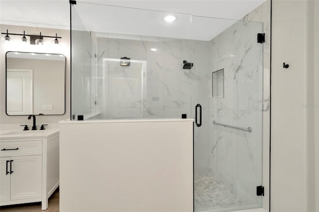 full bathroom featuring recessed lighting, a marble finish shower, and vanity