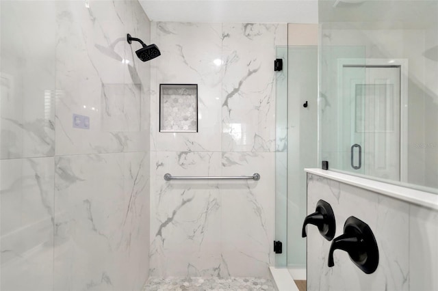 bathroom with a marble finish shower