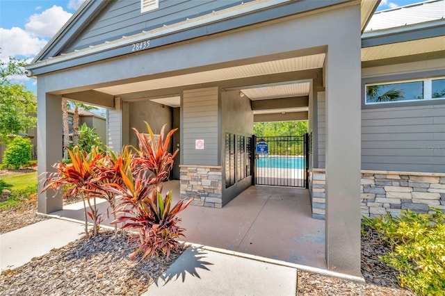 entrance to property featuring stone siding