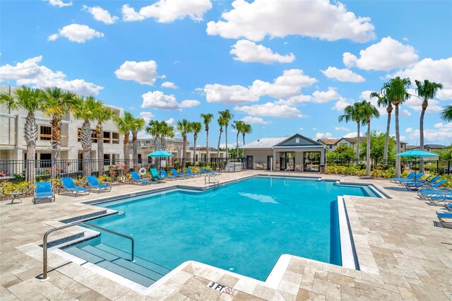 pool featuring a patio area and fence