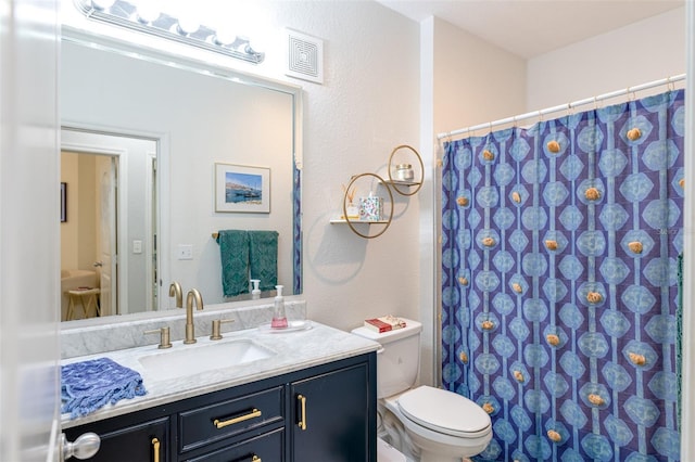 bathroom featuring vanity, a shower with curtain, toilet, and visible vents