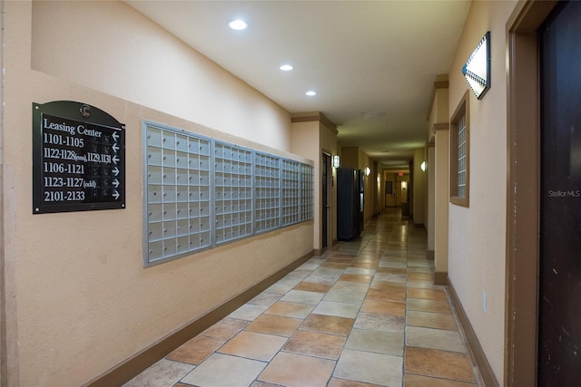 hallway featuring recessed lighting, baseboards, and mail area