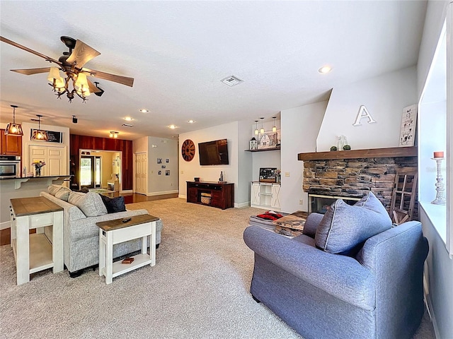 16224 Iola Woods Trl, Dade City, FL 33523 - living area with light colored carpet, a ceiling fan, baseboards, and a fireplace