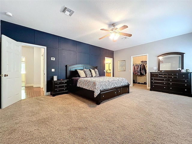 16224 Iola Woods Trl, Dade City, FL 33523 - bedroom with carpet, a ceiling fan, a spacious closet, visible vents, and a closet