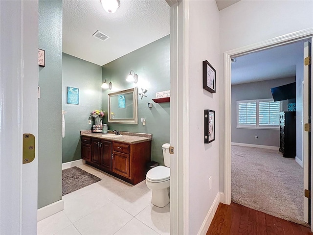 16224 Iola Woods Trl, Dade City, FL 33523 - bathroom featuring baseboards, vanity, toilet, and visible vents