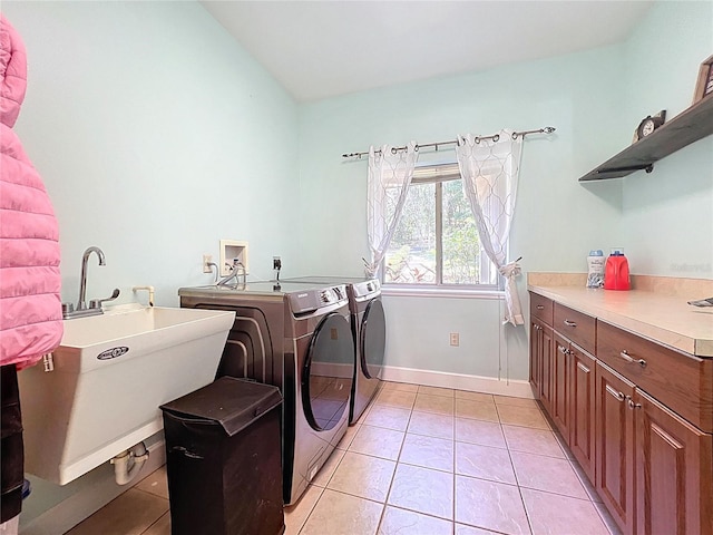 16224 Iola Woods Trl, Dade City, FL 33523 - laundry room featuring washer and dryer, light tile patterned flooring, a sink, and cabinet space