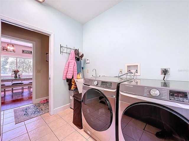 16224 Iola Woods Trl, Dade City, FL 33523 - laundry room featuring laundry area, baseboards, light tile patterned flooring, and washer and dryer