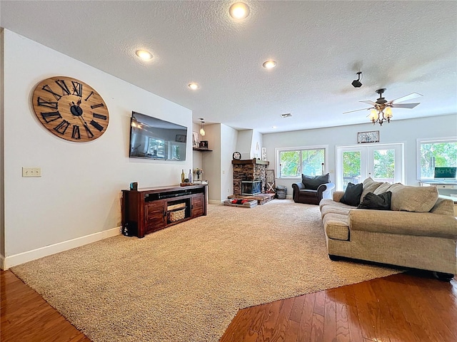 16224 Iola Woods Trl, Dade City, FL 33523 - living room with a textured ceiling, hardwood / wood-style floors, a ceiling fan, and baseboards