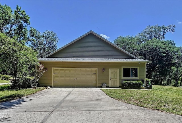 16224 Iola Woods Trl, Dade City, FL 33523 - view of front facade featuring an attached garage, a front lawn, and driveway