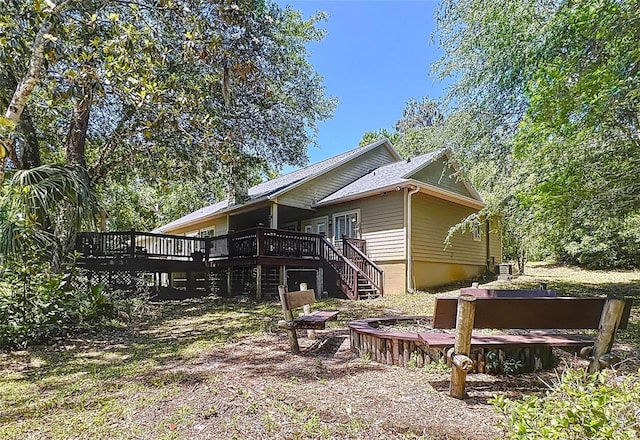 16224 Iola Woods Trl, Dade City, FL 33523 - back of house featuring a deck and stairs