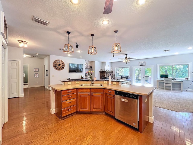 16224 Iola Woods Trl, Dade City, FL 33523 - kitchen with ceiling fan, a textured ceiling, dishwasher, a sink, and open floor plan