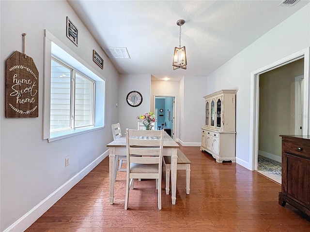 16224 Iola Woods Trl, Dade City, FL 33523 - dining room featuring a chandelier, baseboards, visible vents, and dark wood finished floors