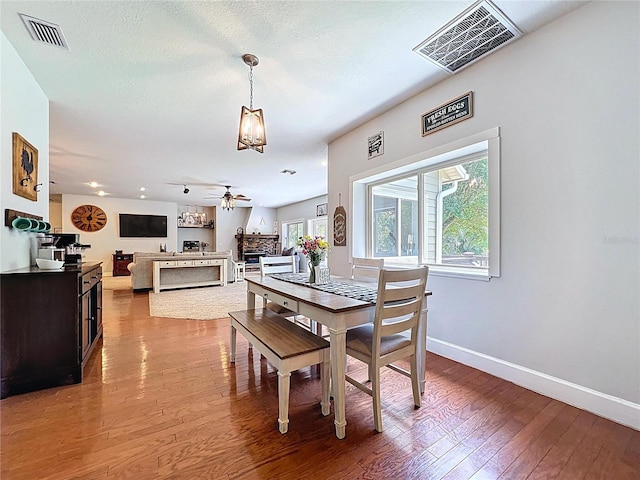 16224 Iola Woods Trl, Dade City, FL 33523 - dining area with visible vents, baseboards, ceiling fan with notable chandelier, and hardwood / wood-style floors
