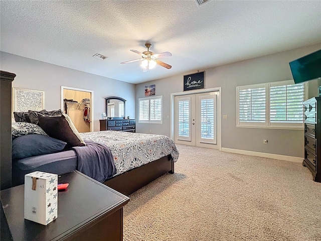 16224 Iola Woods Trl, Dade City, FL 33523 - bedroom with a textured ceiling, visible vents, access to exterior, baseboards, and light carpet