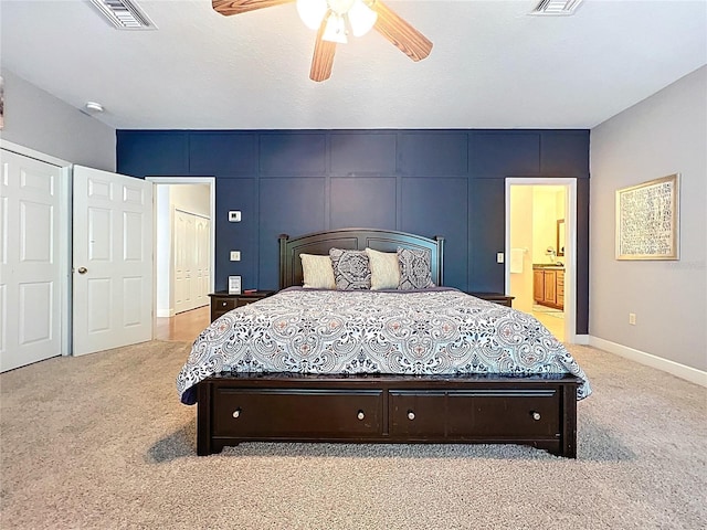 16224 Iola Woods Trl, Dade City, FL 33523 - carpeted bedroom with visible vents, a ceiling fan, baseboards, and connected bathroom