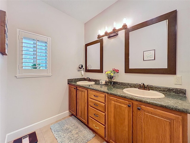 16224 Iola Woods Trl, Dade City, FL 33523 - bathroom featuring double vanity, baseboards, a sink, and tile patterned flooring