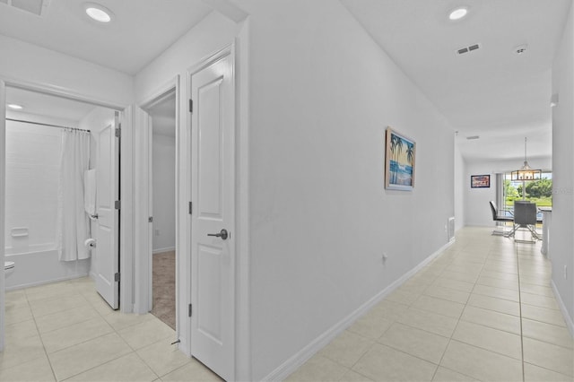 hallway featuring light tile patterned floors, baseboards, recessed lighting, and visible vents