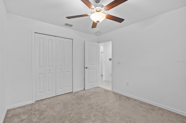 unfurnished bedroom featuring a closet, carpet flooring, and baseboards