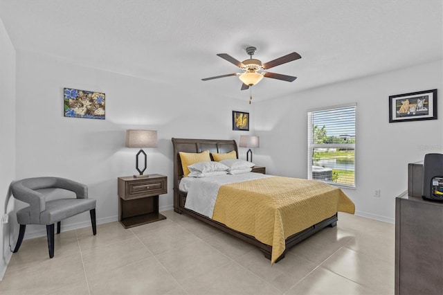 bedroom featuring light tile patterned floors, baseboards, and ceiling fan