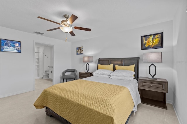 bedroom featuring connected bathroom, light tile patterned flooring, baseboards, and visible vents