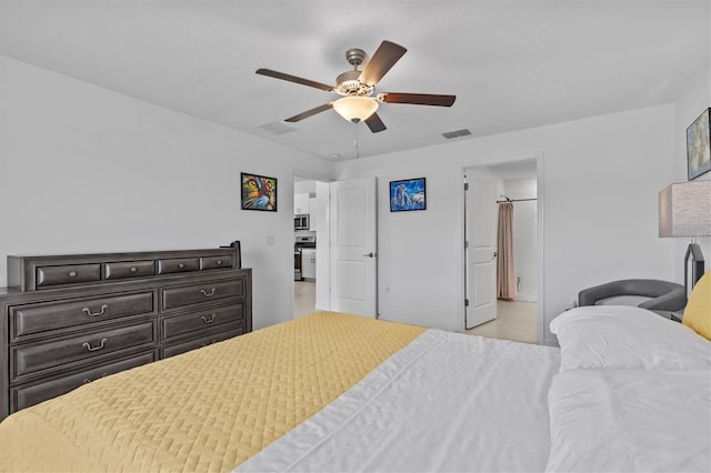 bedroom featuring a ceiling fan, visible vents, and ensuite bathroom