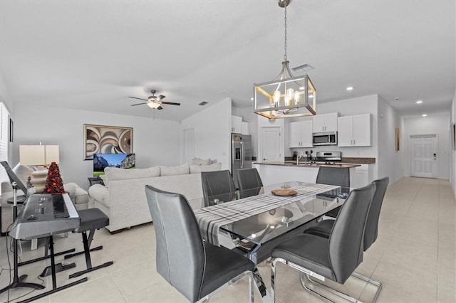 dining area with light tile patterned flooring, visible vents, recessed lighting, and ceiling fan with notable chandelier