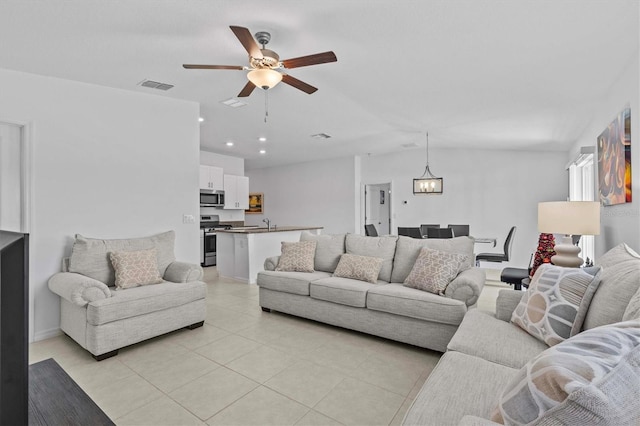 living area featuring a ceiling fan, visible vents, light tile patterned flooring, and recessed lighting
