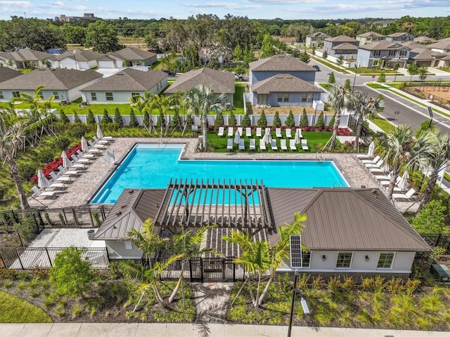 pool with fence and a residential view