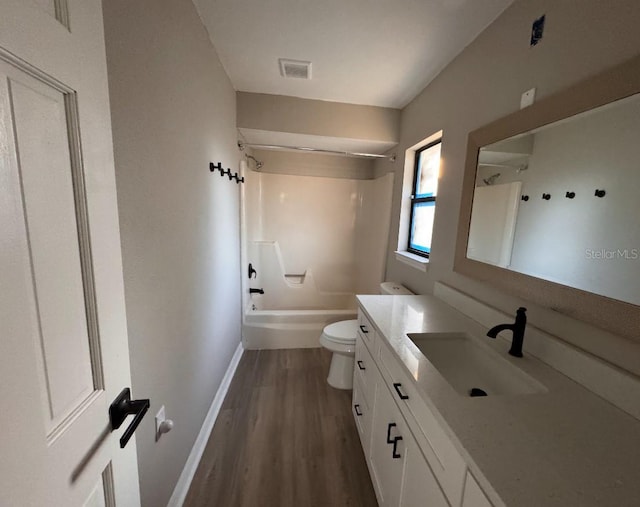 bathroom with visible vents, wood finished floors, baseboards, vanity, and toilet