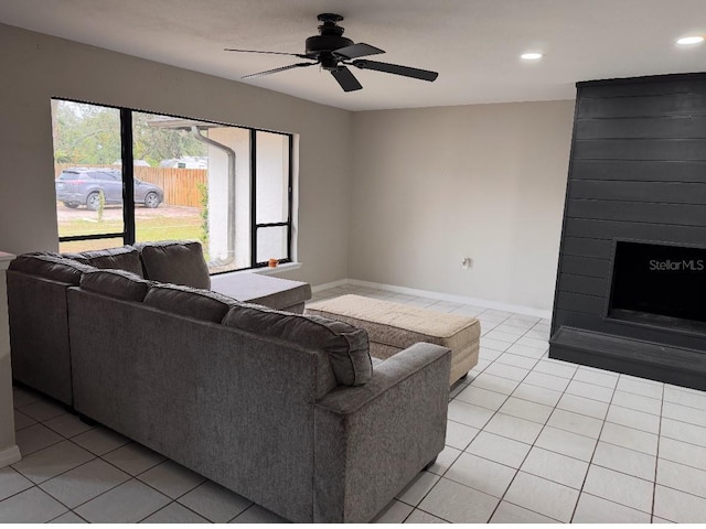 living area with recessed lighting, baseboards, ceiling fan, and light tile patterned floors