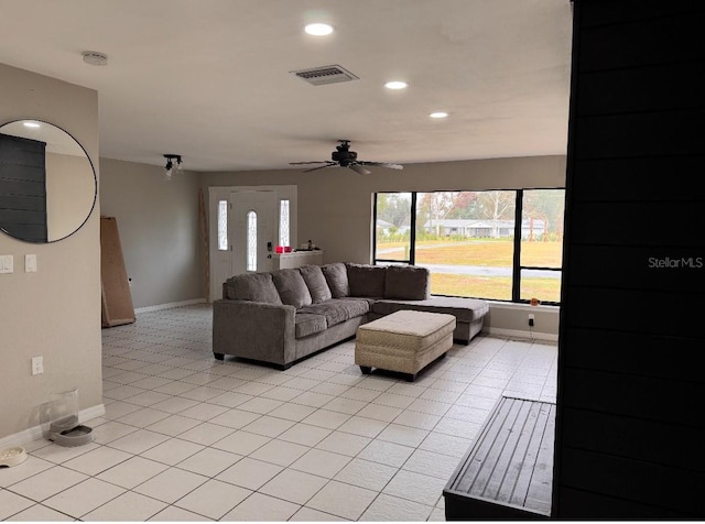 living area featuring a healthy amount of sunlight, baseboards, recessed lighting, and visible vents