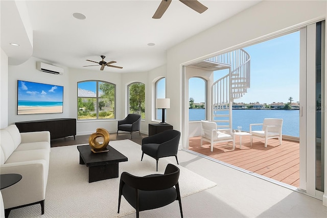living area featuring recessed lighting, a water view, ceiling fan, and an AC wall unit