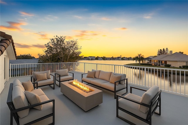 view of patio / terrace with an outdoor living space with a fire pit and a water view