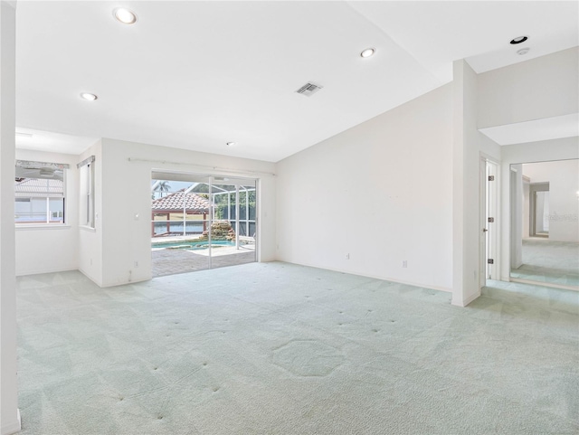 unfurnished living room featuring light colored carpet, visible vents, and recessed lighting