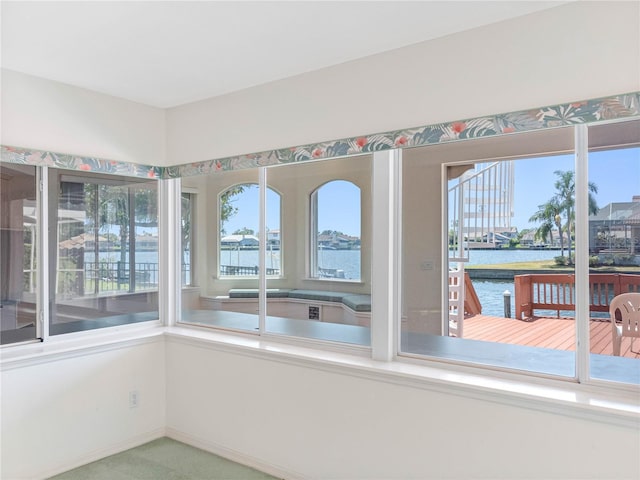 unfurnished sunroom with a water view and a wealth of natural light